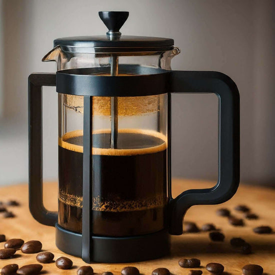 French press coffee maker with dark brew and coffee beans on a wooden surface.