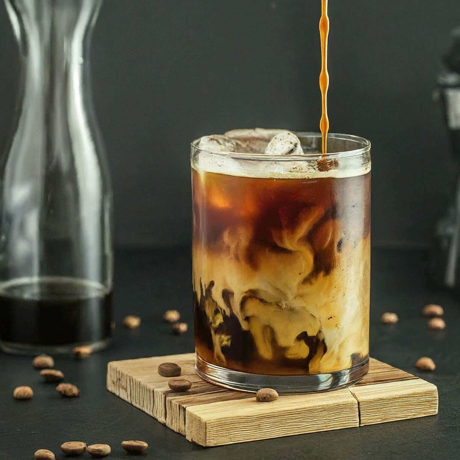 Iced coffee with a swirl of cream, showcasing flavors from Mexico Chiapas's dark roast beans.