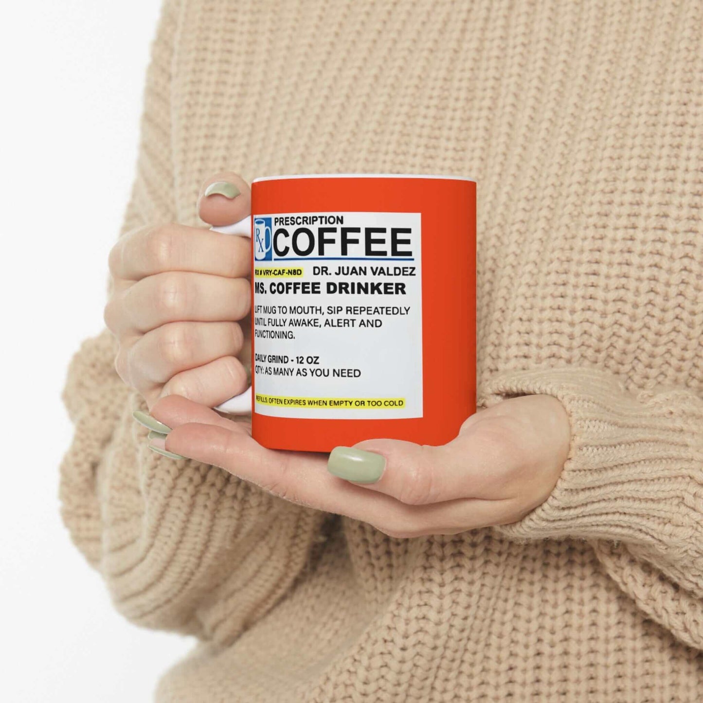 Woman holding Prescription Coffee Mug - For Her (11oz, 15oz) with humorous label design and orange background.