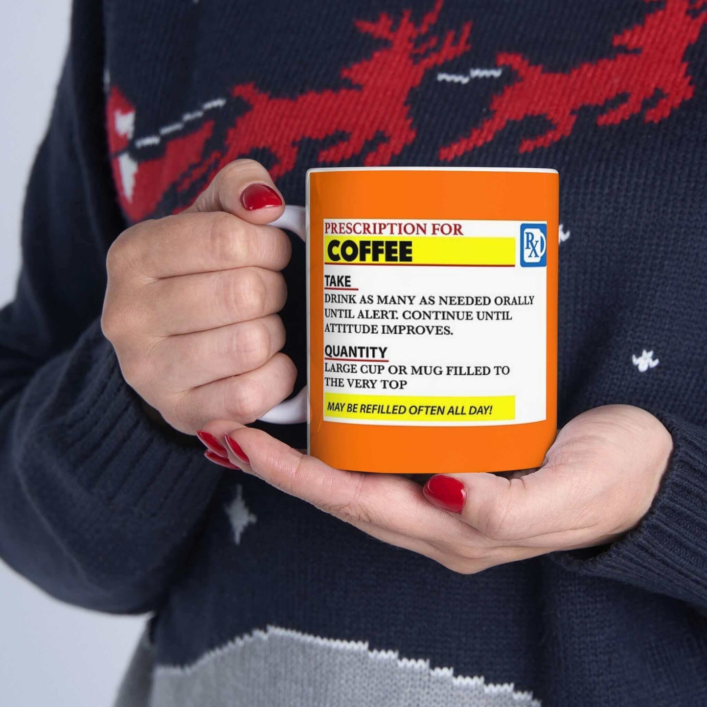 Person holding Prescription Coffee Mug in holiday sweater, featuring humorous prescription label design for coffee lovers.