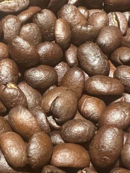 Close-up of House Blend coffee beans showcasing rich, dark roast with hints of nutty sweetness and subtle spice undertones.