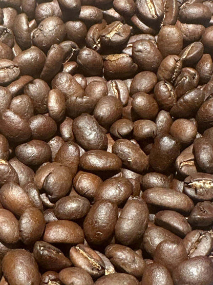 Close-up of House Blend coffee beans with rich brown tones, highlighting the diverse South American and Tanzanian origins.