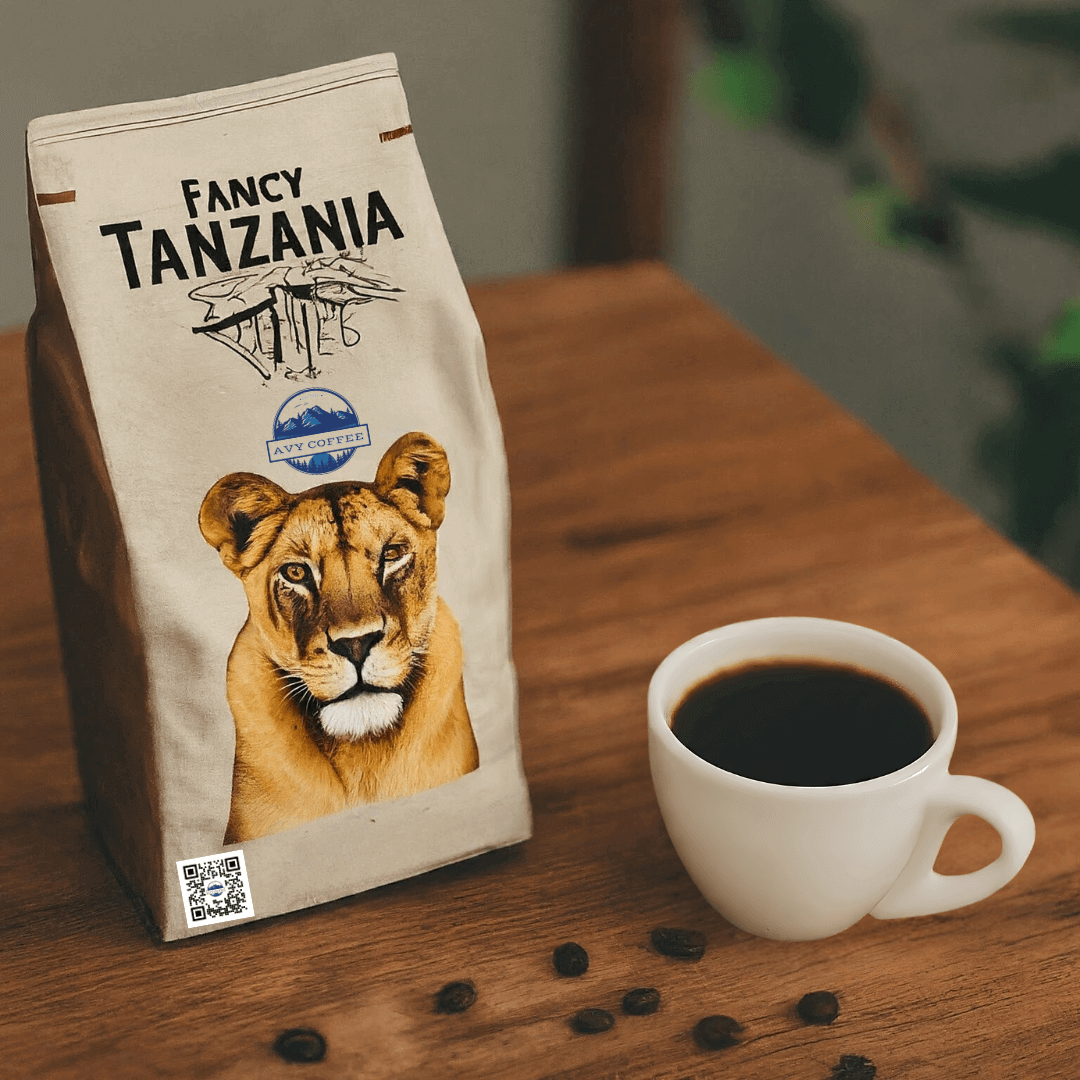 Gourmet Fancy Tanzania coffee bag on a wooden table next to a cup of brewed coffee and scattered coffee beans.