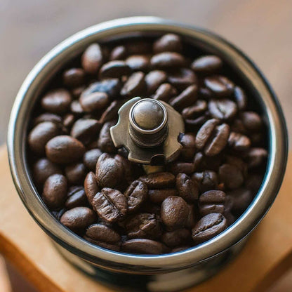 Close-up of dark roasted Organic Mexico Chiapas coffee beans in a grinder, highlighting rich flavor and smooth finish.