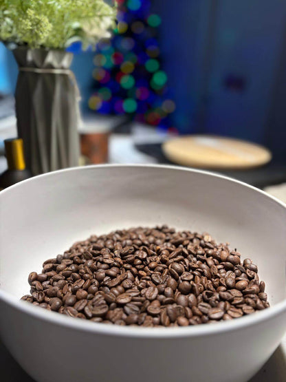 Bowl of medium roast Izzy coffee beans showcasing natural sweetness and balanced flavors, perfect for exploring specialty coffee.