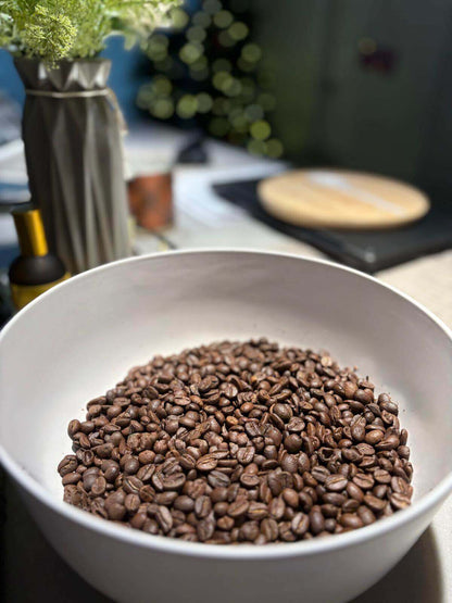 Medium roast Izzy coffee beans with natural sweetness, highlighted in a white bowl, showcasing balanced and smooth flavors.