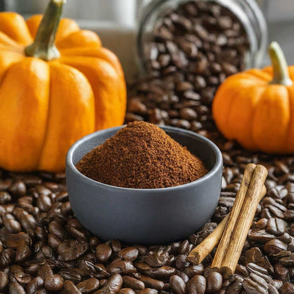 Pumpkin Spice Flavored Coffee with ground coffee in a bowl, surrounded by coffee beans and pumpkins for a cozy fall feel.