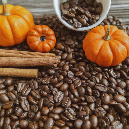 Pumpkin Spice Flavored Coffee beans with cinnamon sticks and mini pumpkins, evoking the essence of fall warmth and flavor.